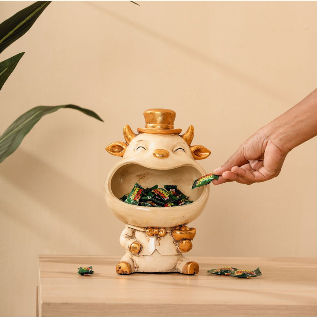 a person putting candy in a ceramic animal