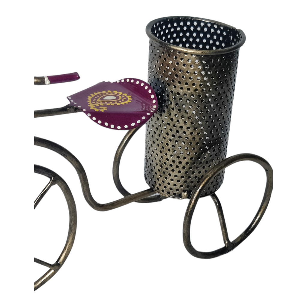 a metal cup with a handle and a flower in it